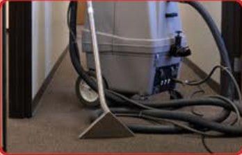 Hot water extraction machine cleaning a carpet
