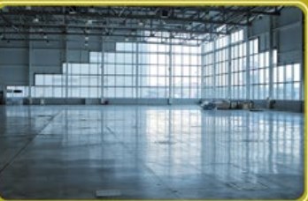 Freshly cleaned polished concrete floor in an empty warehouse