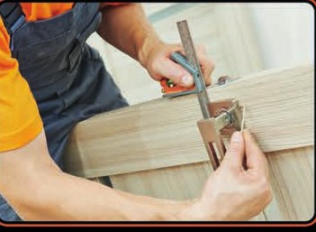 Tradesman fitting a door lock